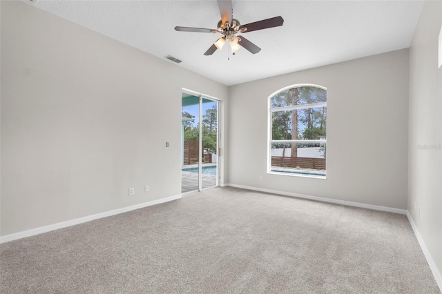 11344 Gallinule Ave, Weeki Wachee, FL 34613 - spare room with a ceiling fan, baseboards, visible vents, and carpet