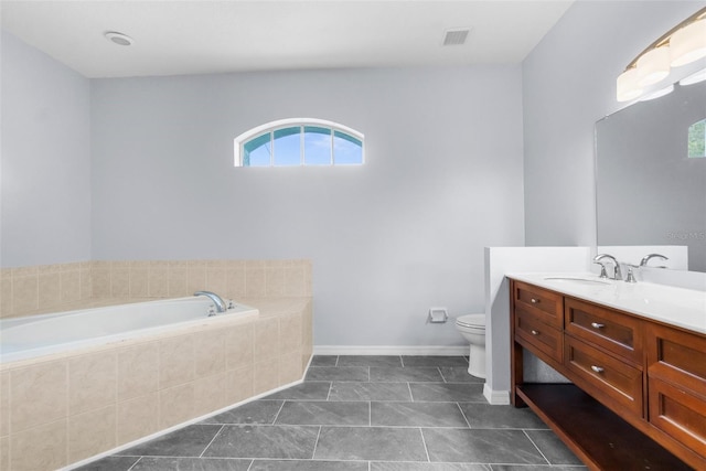 11344 Gallinule Ave, Weeki Wachee, FL 34613 - bathroom with a bath, vanity, tile patterned floors, baseboards, and toilet