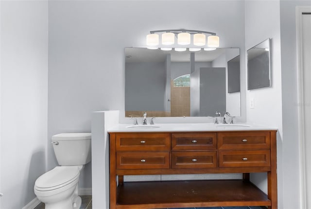 11344 Gallinule Ave, Weeki Wachee, FL 34613 - bathroom featuring double vanity, a sink, baseboards, and toilet