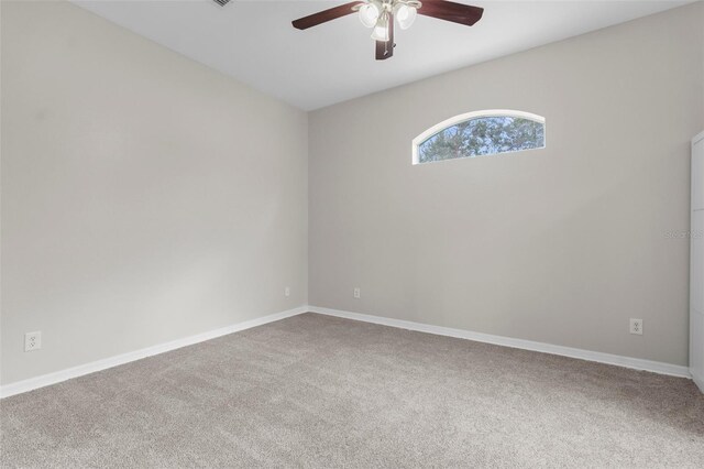 11344 Gallinule Ave, Weeki Wachee, FL 34613 - carpeted spare room with baseboards and a ceiling fan