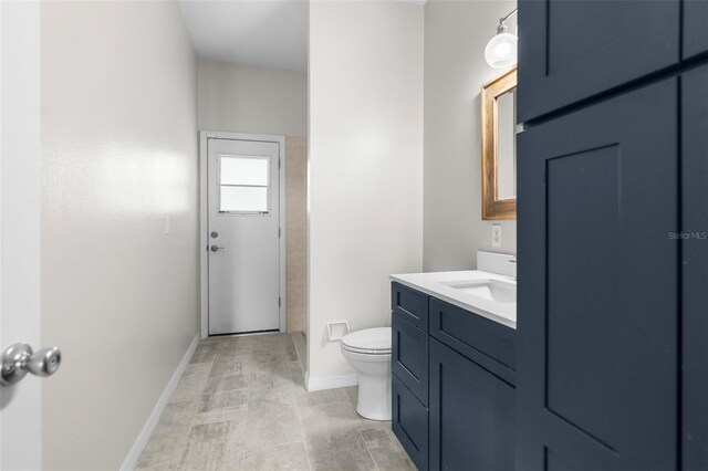 11344 Gallinule Ave, Weeki Wachee, FL 34613 - full bathroom featuring toilet, baseboards, and vanity