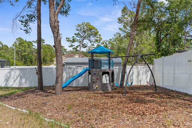 11344 Gallinule Ave, Weeki Wachee, FL 34613 - view of jungle gym with a fenced backyard