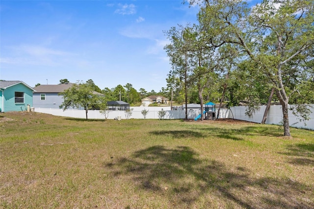 11344 Gallinule Ave, Weeki Wachee, FL 34613 - view of yard with a fenced backyard and a playground