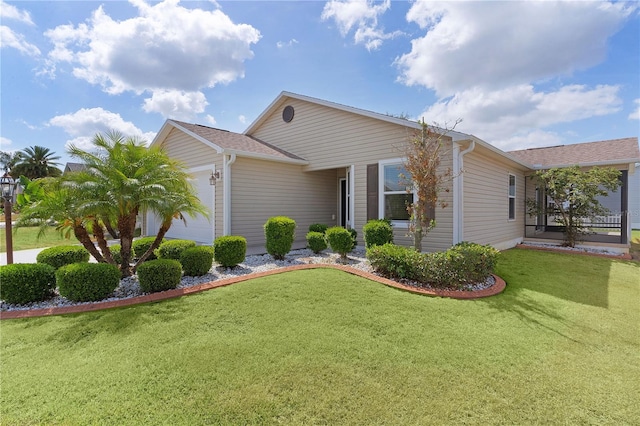 view of side of home featuring a lawn and a garage