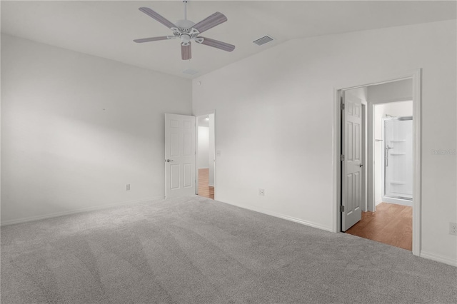 unfurnished bedroom featuring ceiling fan, visible vents, vaulted ceiling, baseboards, and carpet