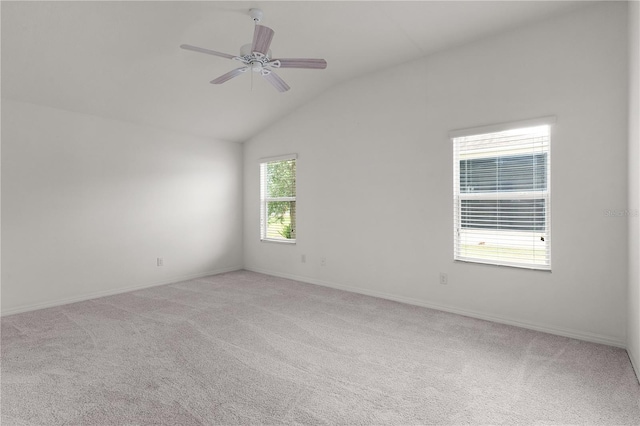 empty room featuring baseboards, light carpet, a ceiling fan, and lofted ceiling