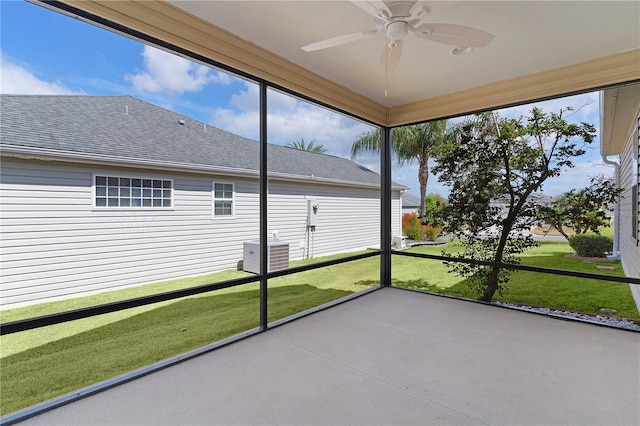 unfurnished sunroom featuring a ceiling fan