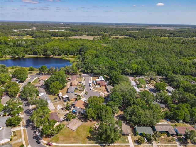 aerial view with a water view, a view of trees, and a residential view