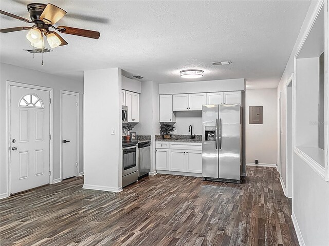 kitchen featuring ceiling fan, visible vents, appliances with stainless steel finishes, white cabinets, and dark wood-type flooring