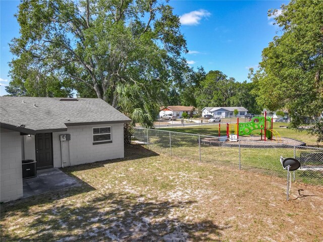 view of yard with fence and a playground