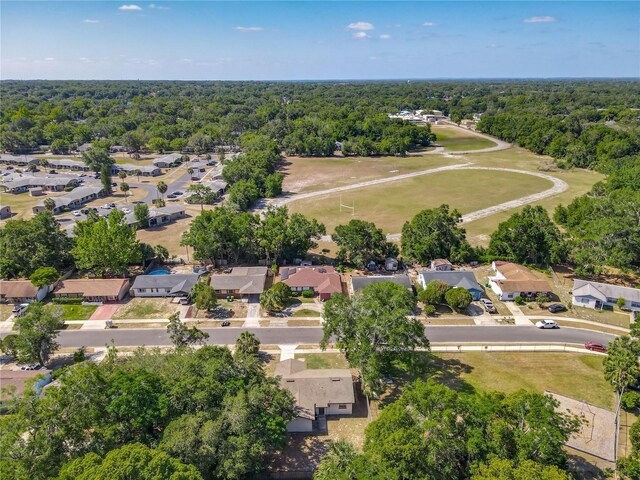 drone / aerial view featuring a residential view and a forest view