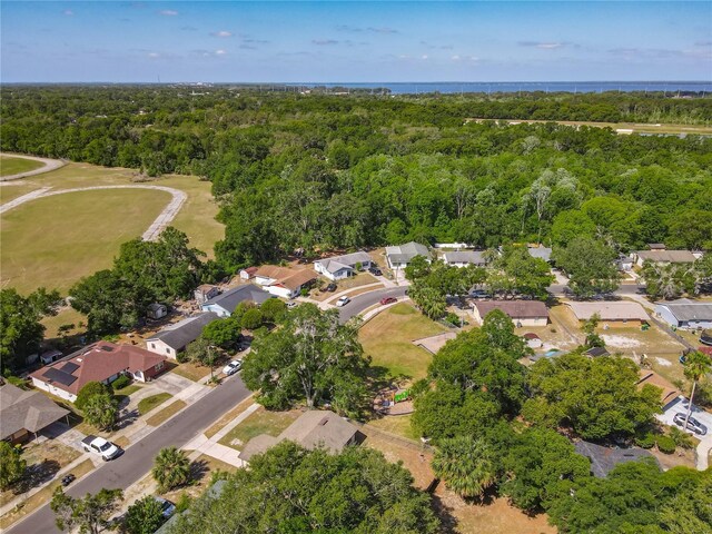 birds eye view of property featuring a view of trees and a residential view
