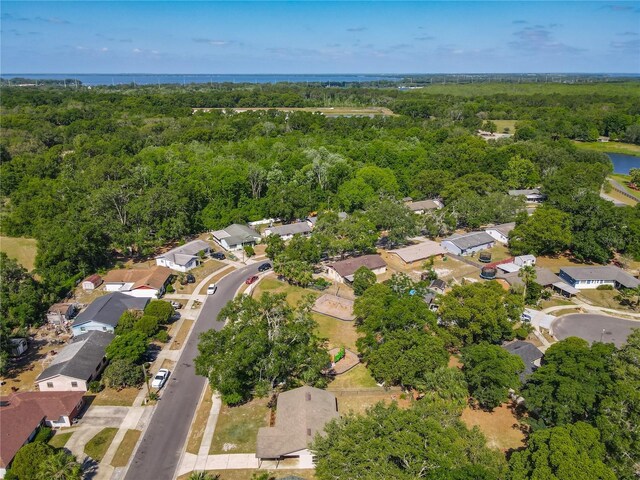 birds eye view of property with a residential view, a view of trees, and a water view