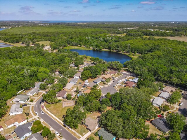 bird's eye view with a water view, a residential view, and a wooded view