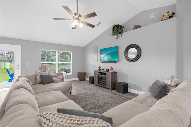 36700 Oconee Ave, Eustis, FL 32736 - living area featuring high vaulted ceiling, light wood-style flooring, a ceiling fan, baseboards, and visible vents
