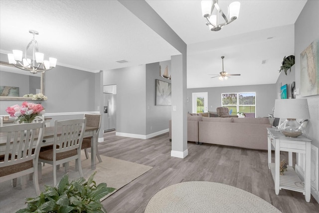 36700 Oconee Ave, Eustis, FL 32736 - dining area with baseboards, visible vents, ceiling fan with notable chandelier, and light wood-type flooring