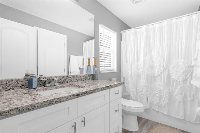 36700 Oconee Ave, Eustis, FL 32736 - full bathroom with vanity, shower / tub combo with curtain, wood finished floors, and toilet