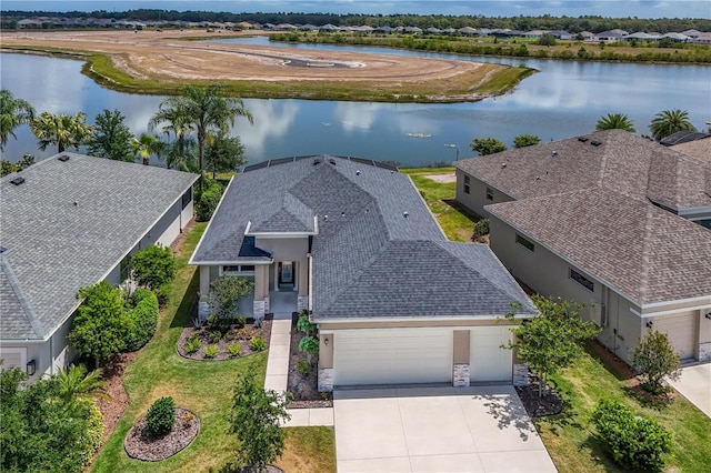 drone / aerial view featuring a residential view and a water view
