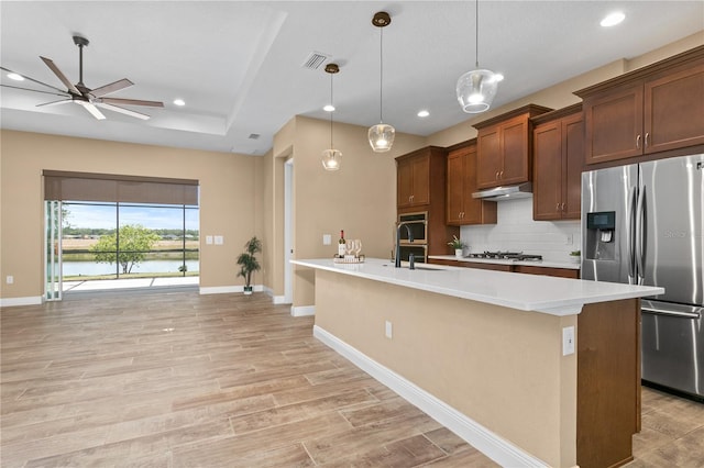 kitchen featuring recessed lighting, ceiling fan, decorative backsplash, light countertops, and appliances with stainless steel finishes