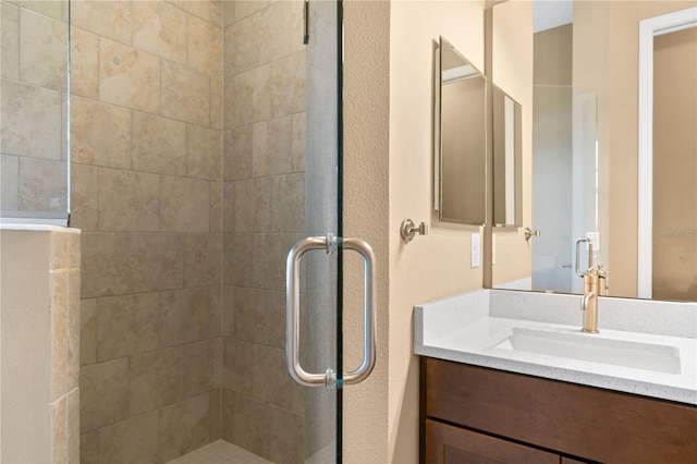 bathroom featuring vanity and a stall shower