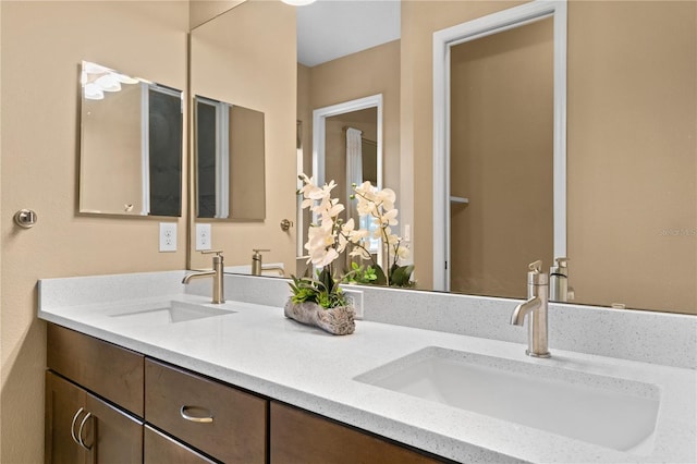 bathroom with a sink and double vanity