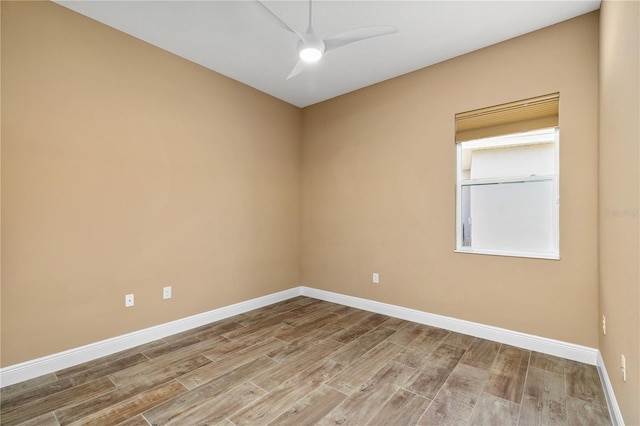 unfurnished room featuring baseboards, a ceiling fan, and wood finished floors