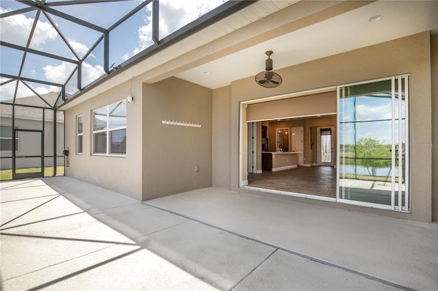 doorway to property featuring stucco siding and a patio area