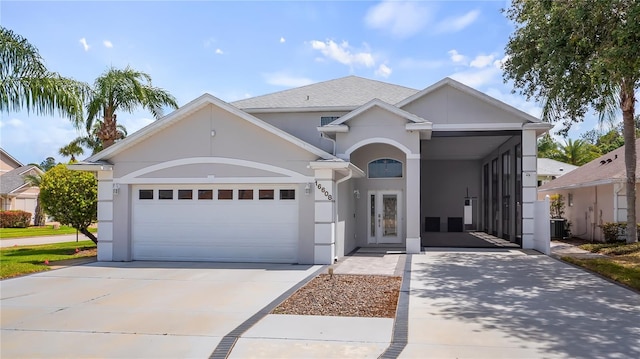 single story home featuring concrete driveway, an attached garage, stucco siding, and central AC