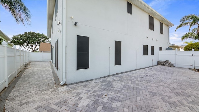 back of house with a patio and stucco siding