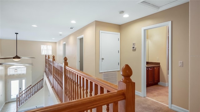 hall featuring visible vents, an upstairs landing, baseboards, and recessed lighting