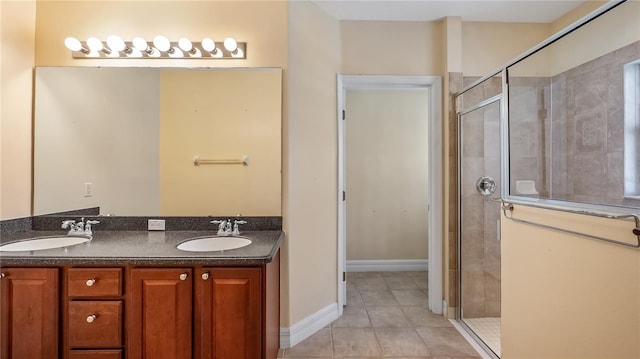 full bath with a sink, tile patterned flooring, and a stall shower