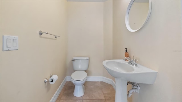 bathroom with tile patterned floors, toilet, and baseboards