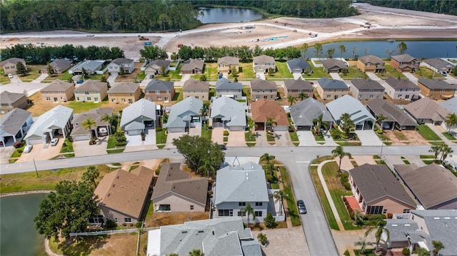 drone / aerial view with a water view and a residential view