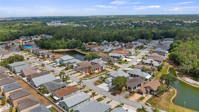 birds eye view of property featuring a water view, a forest view, and a residential view