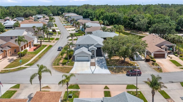 birds eye view of property featuring a forest view and a residential view