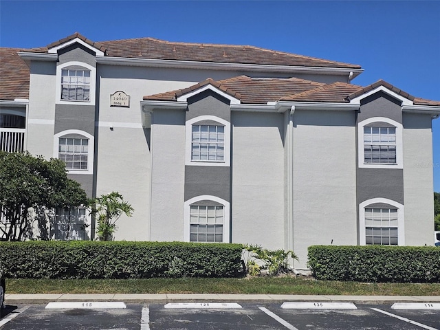14049 Fairway Island Dr Unit 118, Orlando, FL 32837 - view of building exterior with uncovered parking