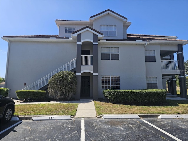 14049 Fairway Island Dr Unit 118, Orlando, FL 32837 - view of property featuring uncovered parking and stairway