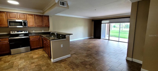 14049 Fairway Island Dr Unit 118, Orlando, FL 32837 - kitchen with stainless steel appliances, baseboards, dark countertops, and a peninsula