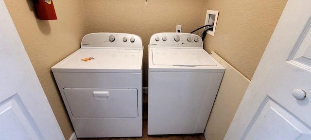 14049 Fairway Island Dr Unit 118, Orlando, FL 32837 - washroom featuring separate washer and dryer, laundry area, and a textured wall
