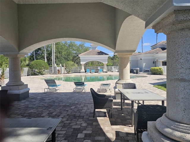 14049 Fairway Island Dr Unit 118, Orlando, FL 32837 - view of patio with a community pool and fence