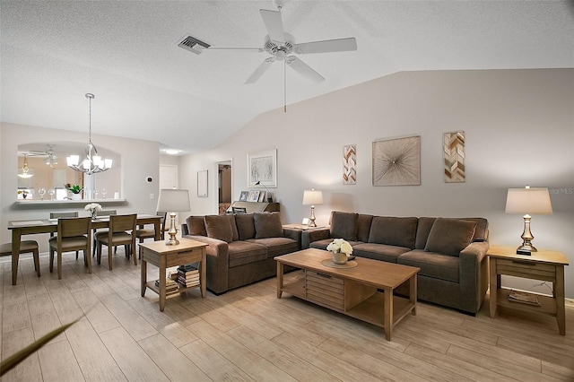 1318 Guerra Ave, The Villages, FL 32159 - living area featuring visible vents, light wood-style flooring, lofted ceiling, and ceiling fan with notable chandelier
