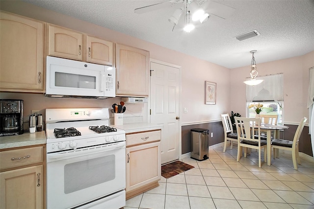 1318 Guerra Ave, The Villages, FL 32159 - kitchen featuring ceiling fan, light brown cabinets, white appliances, light countertops, and a textured ceiling