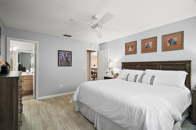 1318 Guerra Ave, The Villages, FL 32159 - bedroom with visible vents, a textured ceiling, light wood-style floors, and baseboards