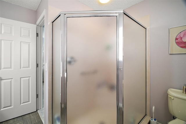 1318 Guerra Ave, The Villages, FL 32159 - bathroom with a stall shower, toilet, and a textured ceiling