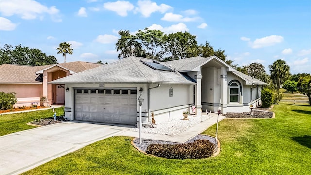 5500 Laver St, Leesburg, FL 34748 - view of front facade with driveway, roof mounted solar panels, a front lawn, an attached garage, and a shingled roof