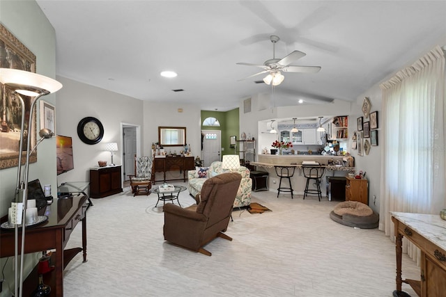 5500 Laver St, Leesburg, FL 34748 - living area featuring visible vents, a ceiling fan, vaulted ceiling, and light carpet