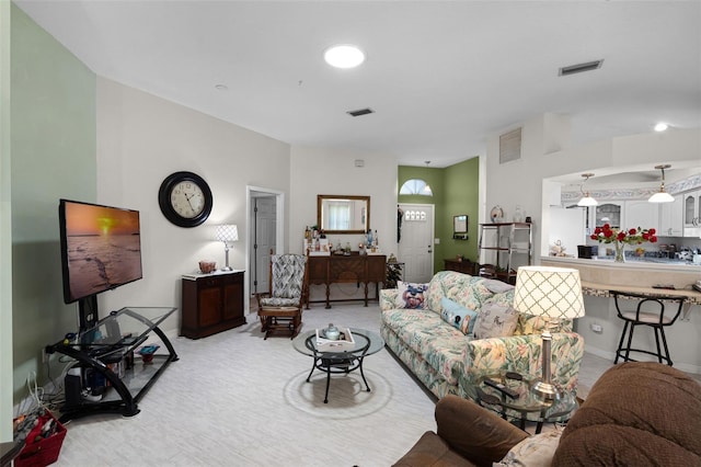 5500 Laver St, Leesburg, FL 34748 - living room featuring visible vents, baseboards, and light carpet