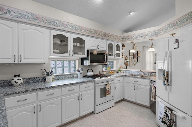 5500 Laver St, Leesburg, FL 34748 - kitchen with white cabinets, stainless steel appliances, a sink, and glass insert cabinets