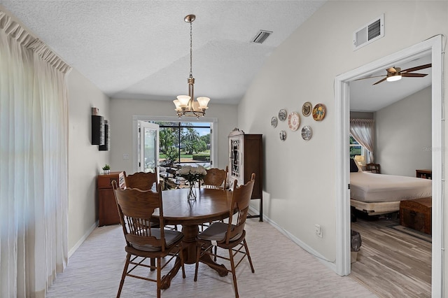5500 Laver St, Leesburg, FL 34748 - dining room with light wood-style floors, visible vents, a textured ceiling, and lofted ceiling
