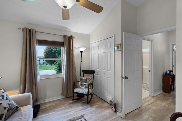 5500 Laver St, Leesburg, FL 34748 - sitting room with light wood-type flooring, a textured ceiling, ceiling fan, and vaulted ceiling